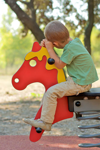 boy on playground horse
